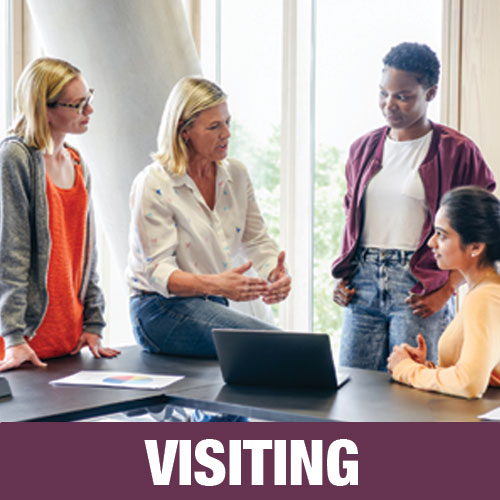 An instructor have a conversation with a group of students