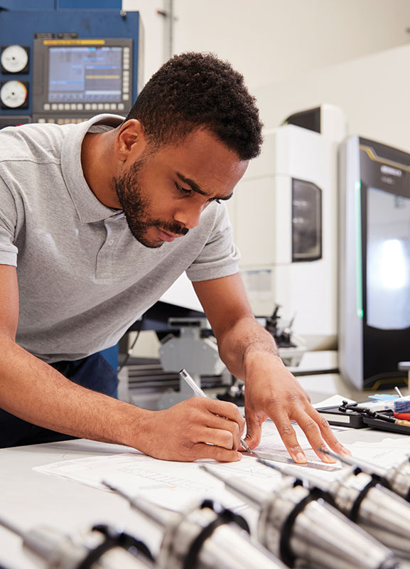 Engineer designing a part for manufacture