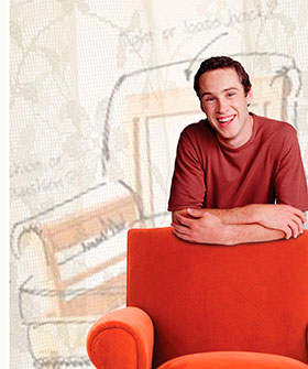 Man leaning on an upholstery chair