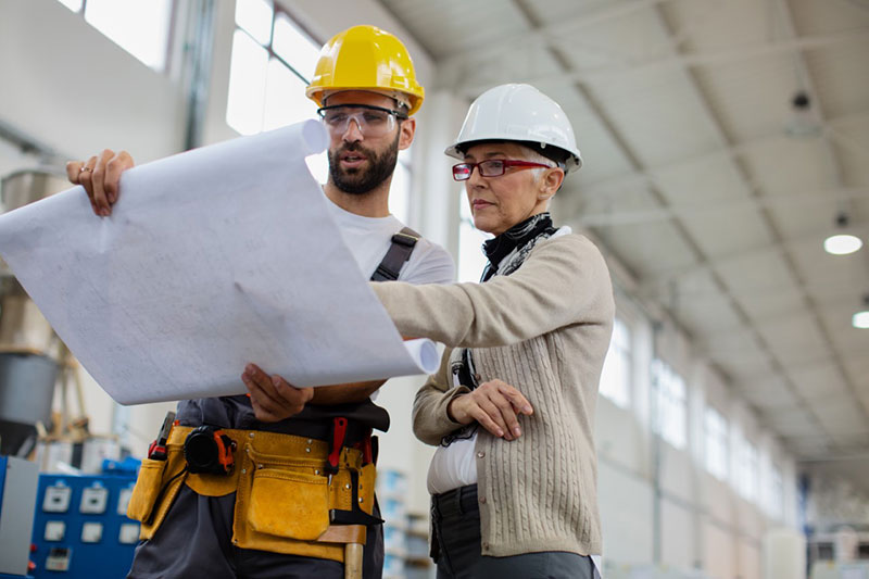 Technician reviewing blueprints