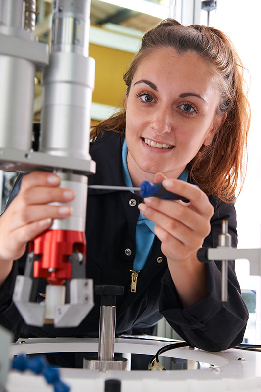 Technician working on a piece of industrial equipment