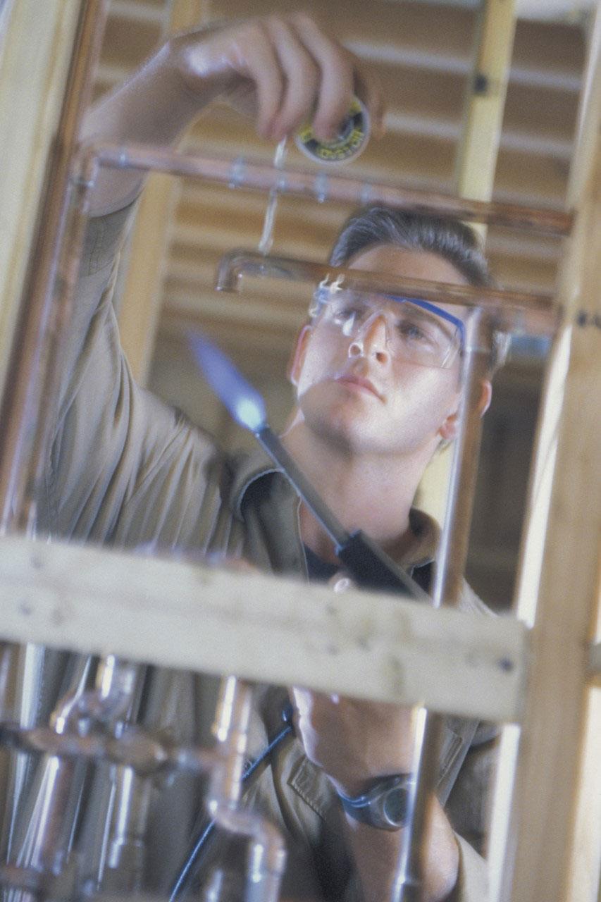 Plumber assembling pipes