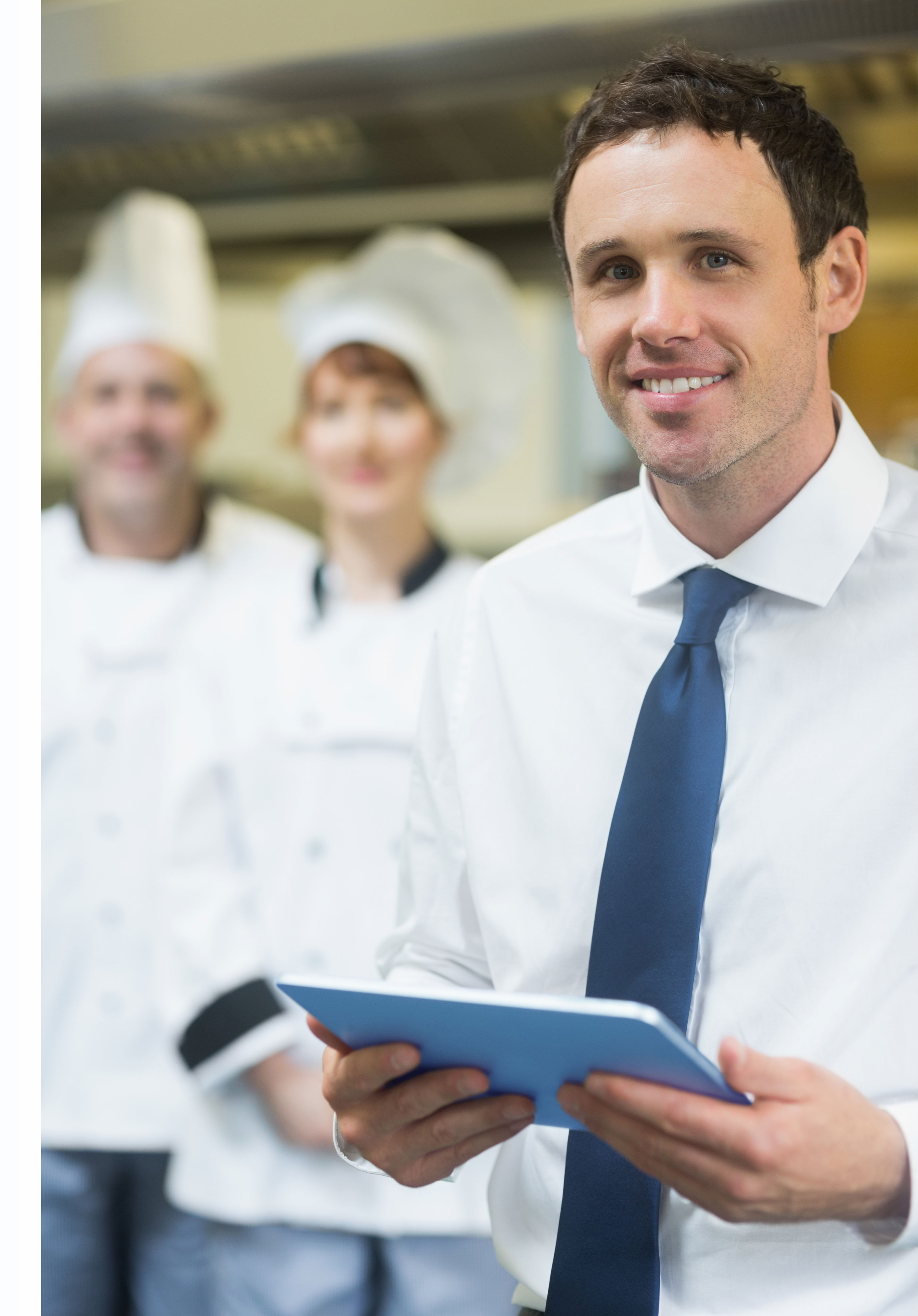 Hospitality Manager with chefs in the background