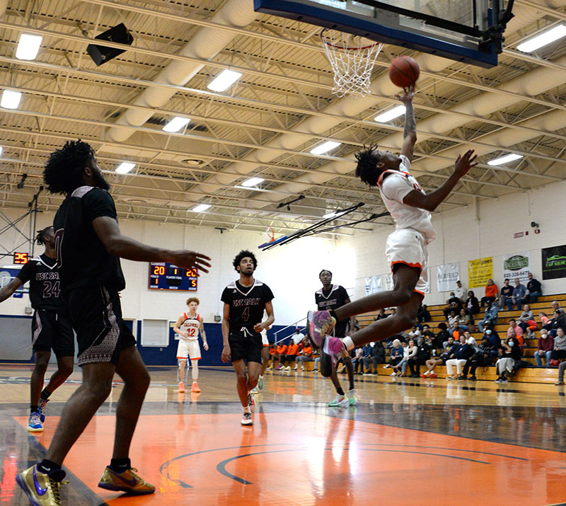 CCC&TI guard Shawn Nelson (5) drives to the basket with a reverse layup.